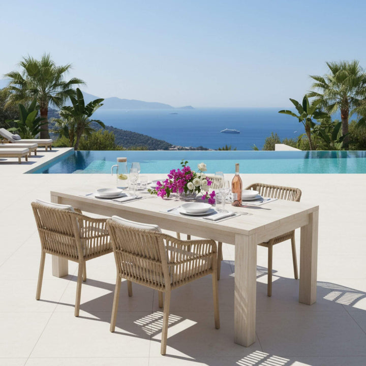 Outdoor dining setup by the sea featuring the Ellen Garden table.