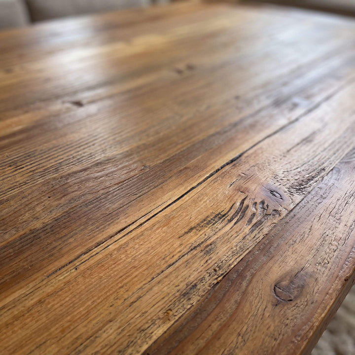 Detailed view of the Elm Wood tabletop highlighting its warm tones, grain, knots, and natural texture