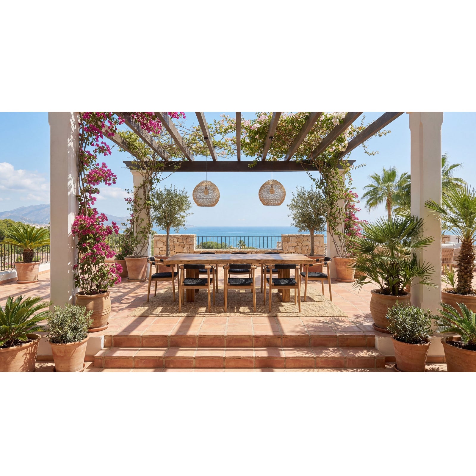 Outdoor dining area with a table and chairs under a pergola, overlooking the ocean.