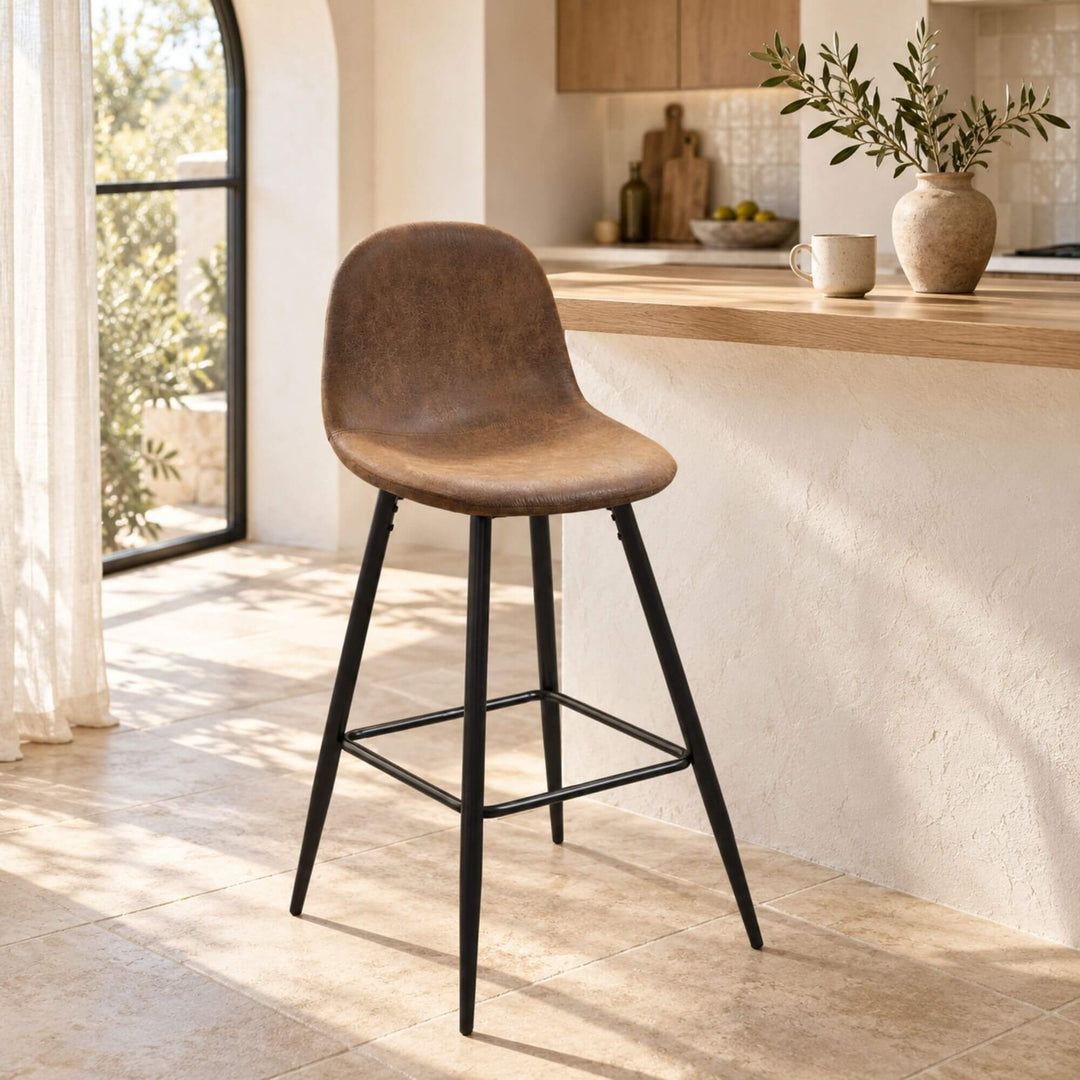 Enzo bar stool styled beside a kitchen counter in a warm Mediterranean-inspired interior