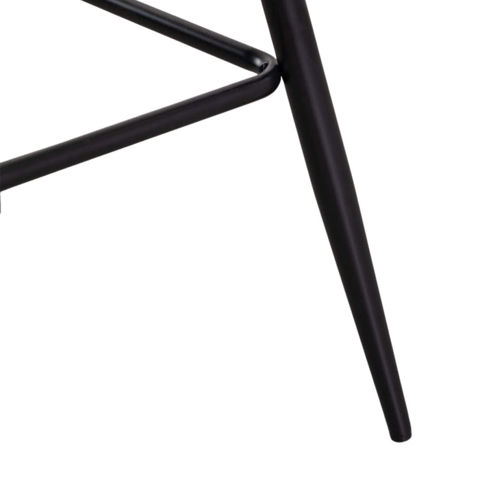 Close-up of the Enzo bar stool highlighting the black steel legs and integrated footrest