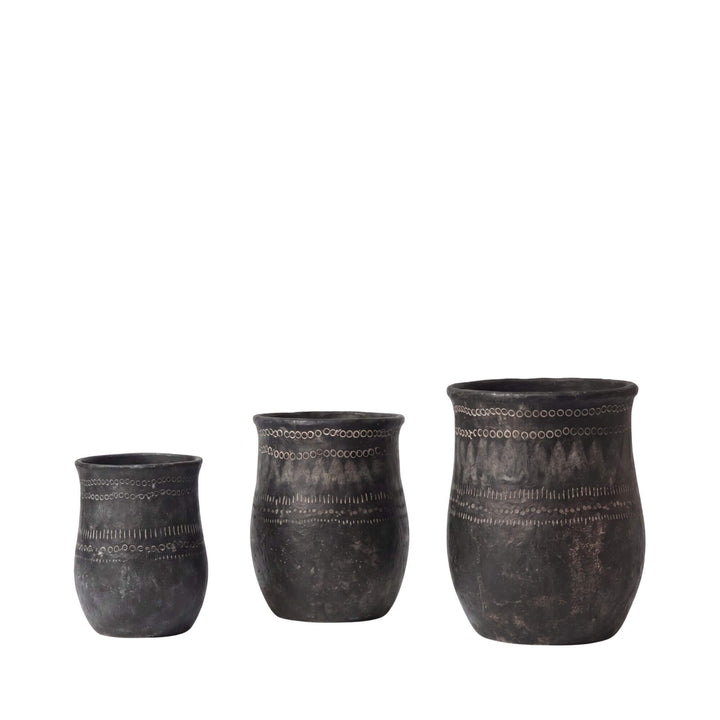 Set of three etched black planters showing their rounded silhouettes and textured finish.