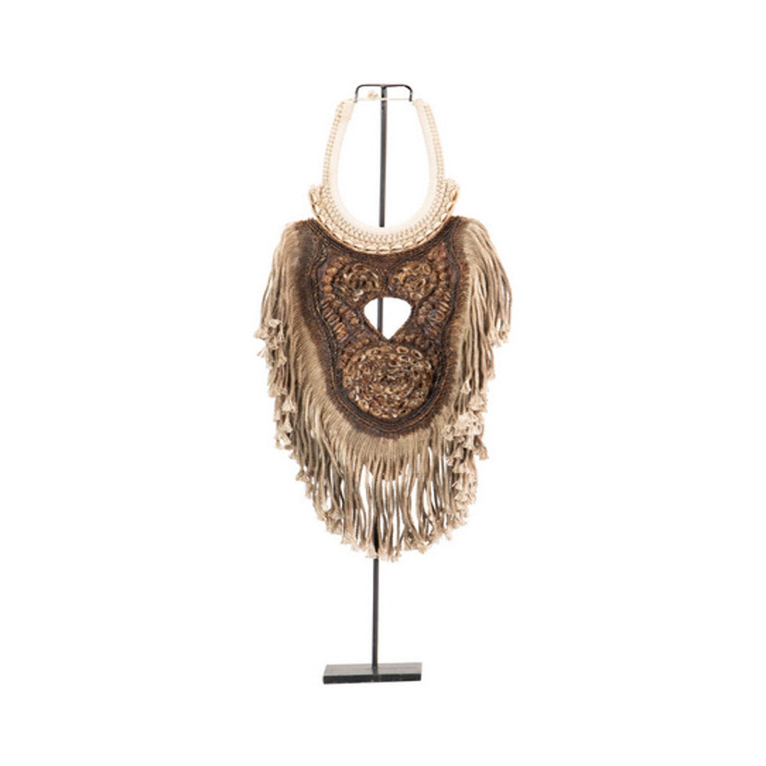 Front view of the ethnic necklace stand featuring shells, cotton fringe, and carved wood details.