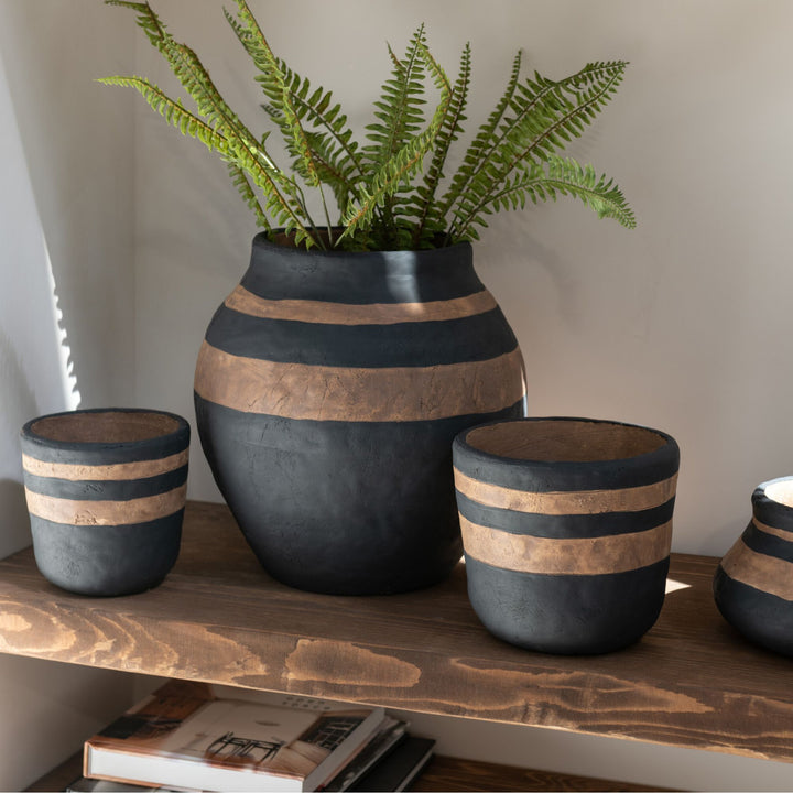 Styled interior setting featuring Ethnic Stripes pots arranged on a shelf.