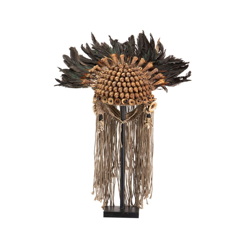 Front view of Handmade ethnic sculpture stand with shells, feathers, and fringe