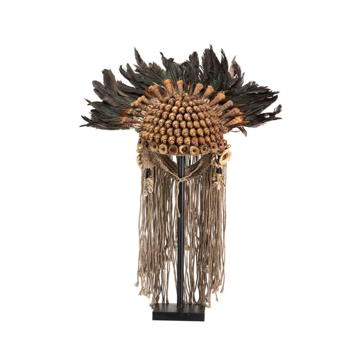 Front view of Handmade ethnic sculpture stand with shells, feathers, and fringe