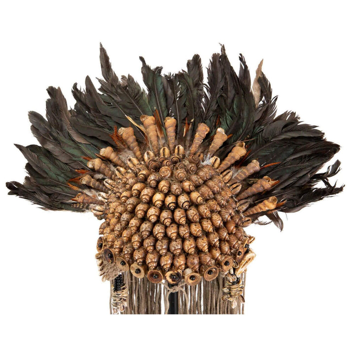 Close-up of Ethnic necklace stand with natural shells and feathers on metal base
