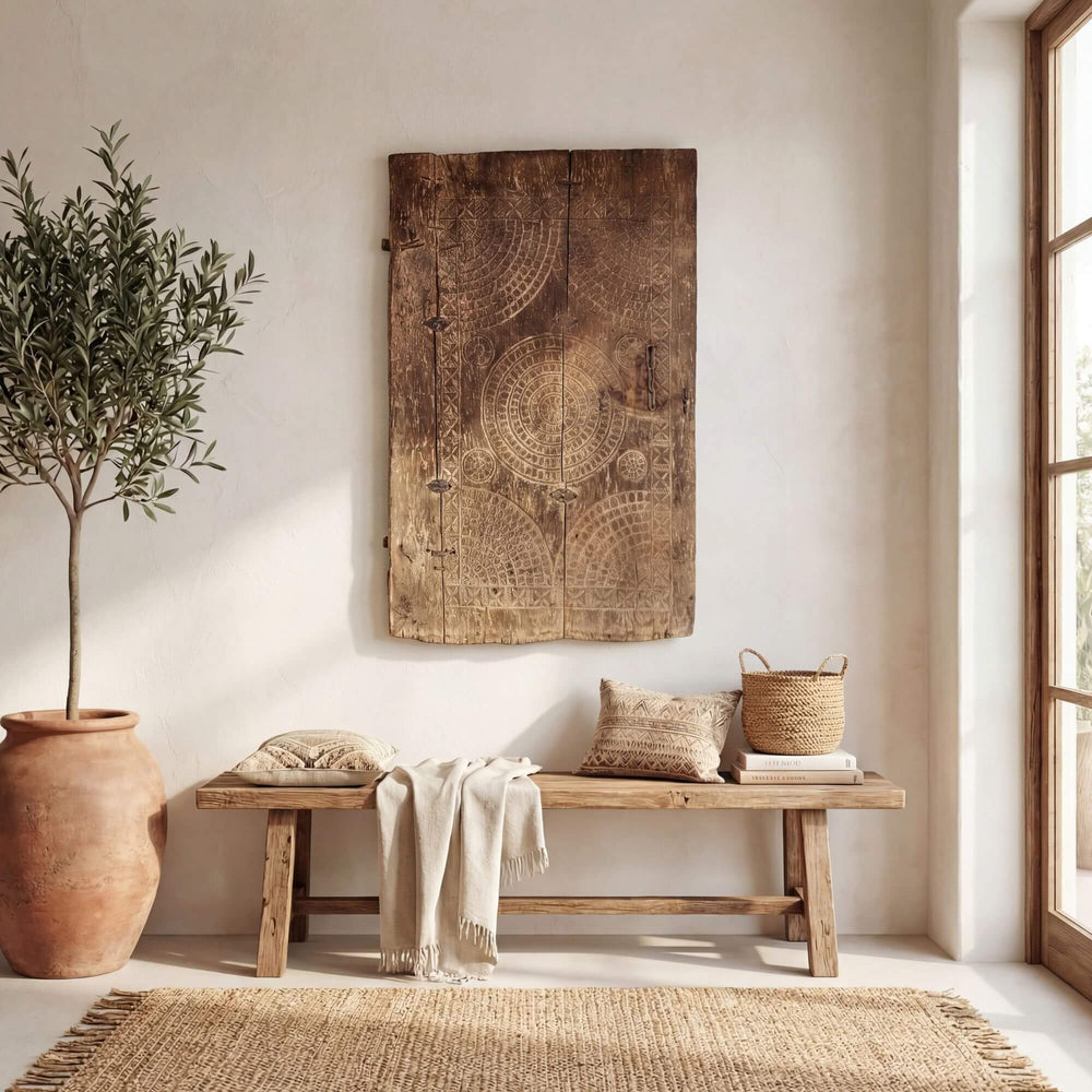 Interior setting showing the antique wooden door used as a decorative wall panel.