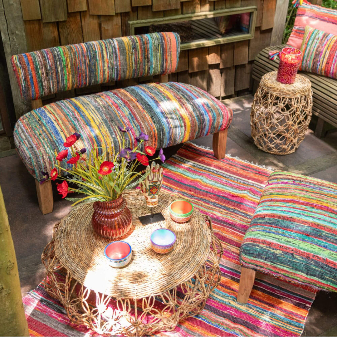 Front view of the Farsha Chindi Sofa with multicolored recycled fabric and wooden legs.