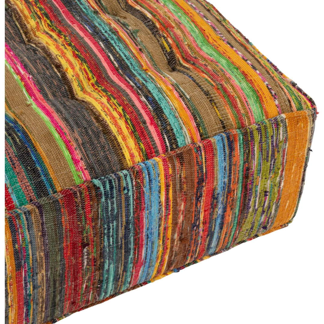 Angled close-up view of striped chindi fabric wrapping around pouf corner