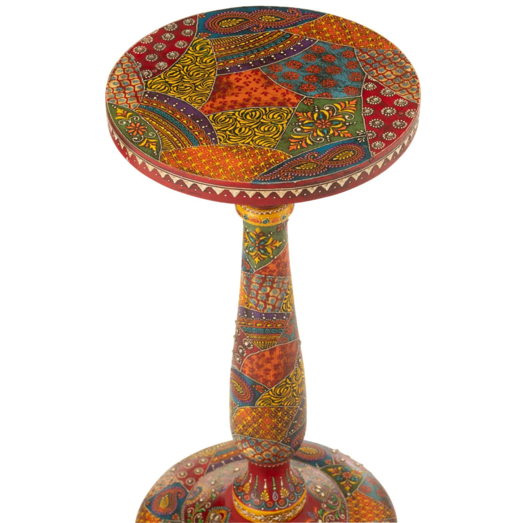 Top view of round tabletop showing multicolor patchwork pattern and decorative studs
