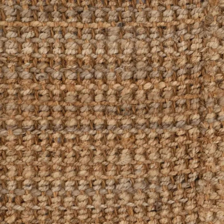 Detail view of the Fati jute rug highlighting its warm earthy tones and organic fiber texture