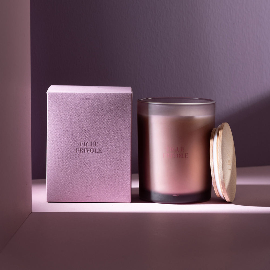 Figue Frivole candle styled on a shelf with soft lighting and packaging.