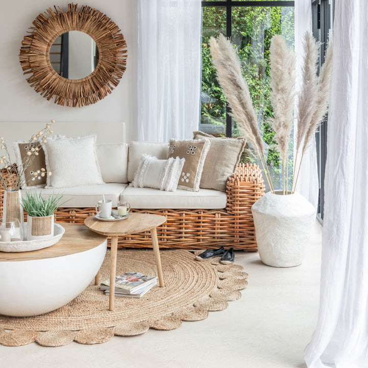 Styled interior scene featuring the Flor Round Jute Rug in a bright living room.