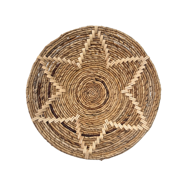 Round woven mat with concentric circle pattern on a white background