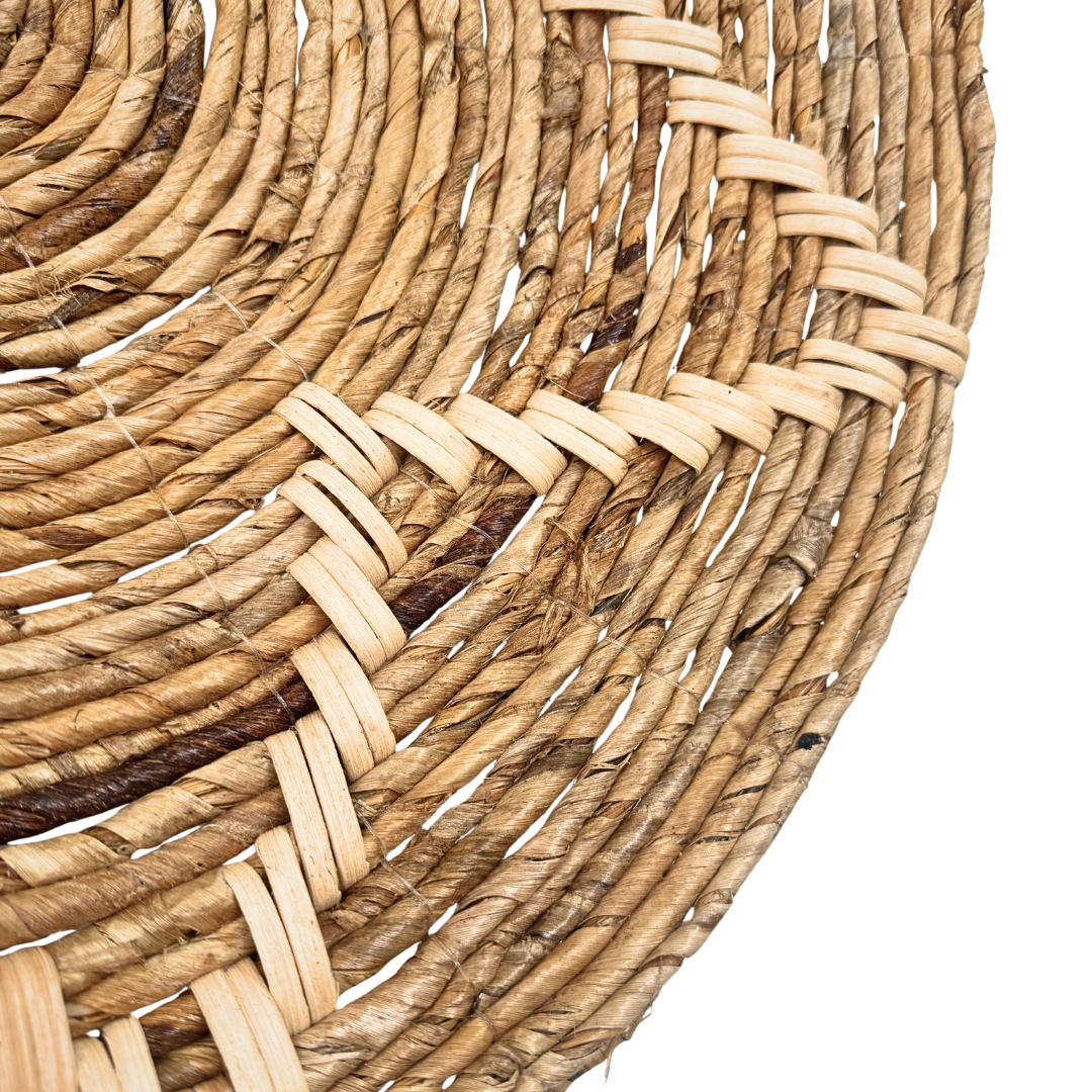 Close-up of a woven basket with natural fiber on a white background