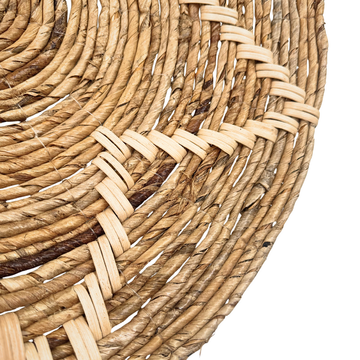 Close-up of a woven basket with natural fiber on a white background