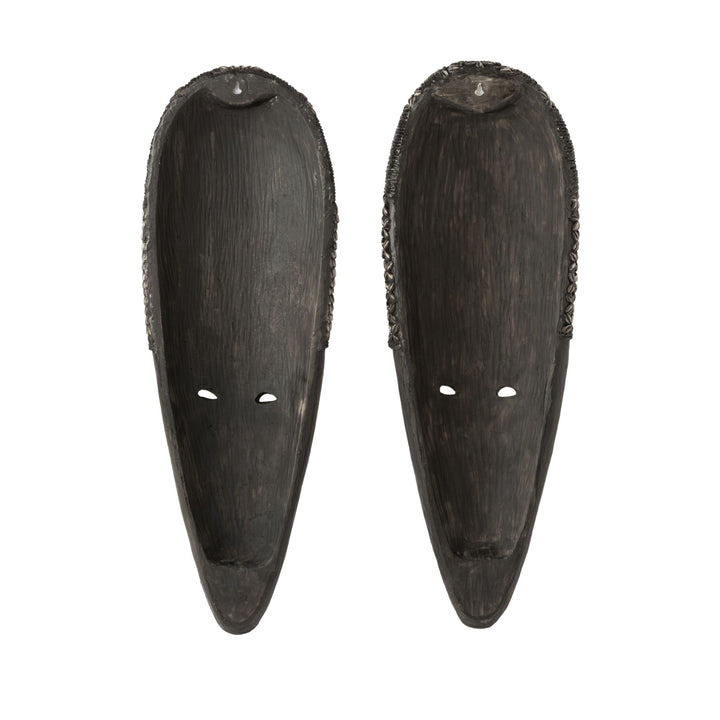 Pair of Frailes wood masks displayed side by side highlighting handcrafted texture and recycled materials.