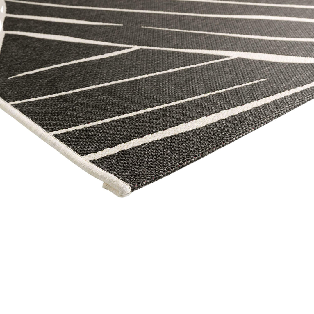 Close-up of the Freek rug showing the polypropylene texture and raised pattern.