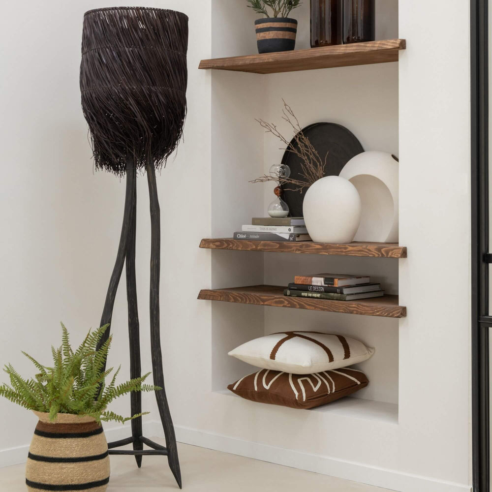 Decorative interior with a black Fury floor lamp, plants, and shelves with decorative items.