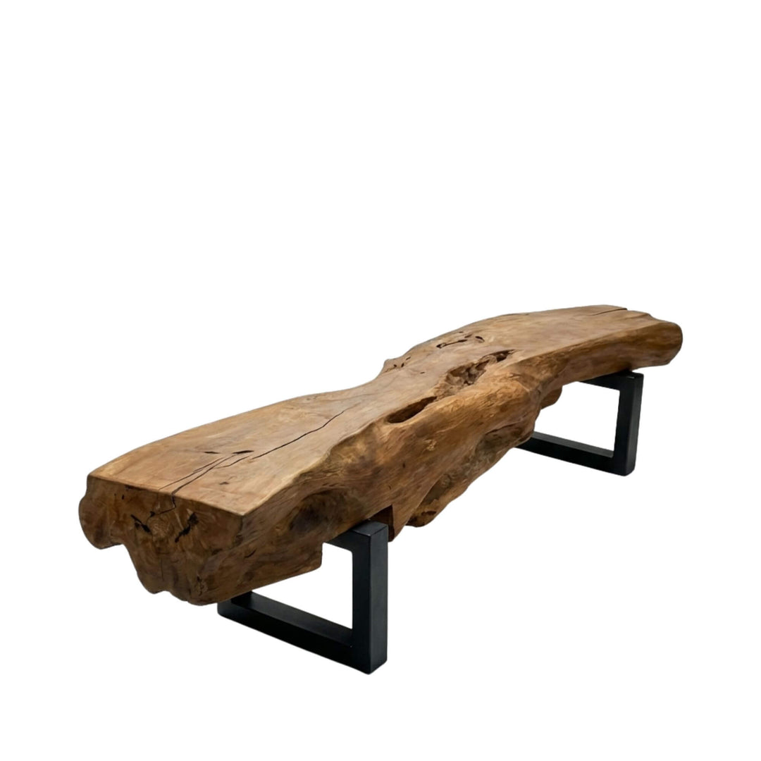 Front view of the Gandalf teak wood bench showing its sculptural root top and black iron base.