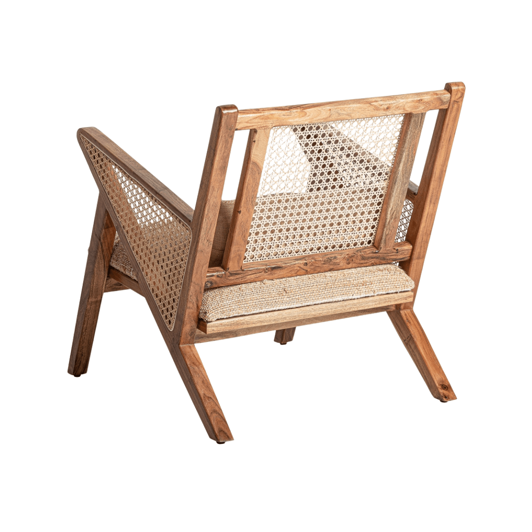 Rear angled view of Ganda lounge chair showing rattan backrest and wooden frame