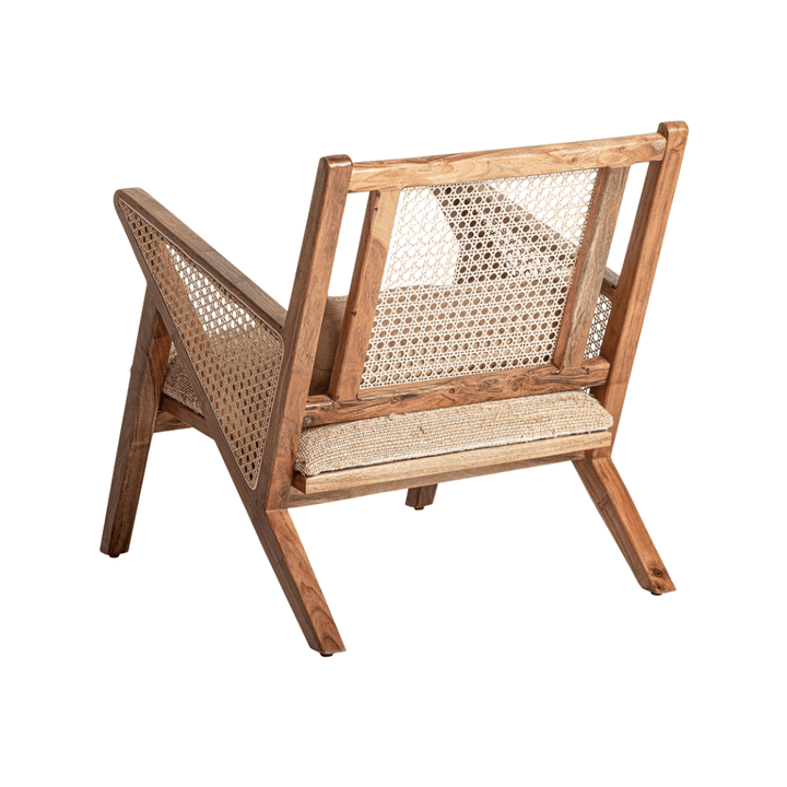 Rear angled view of Ganda lounge chair showing rattan backrest and wooden frame
