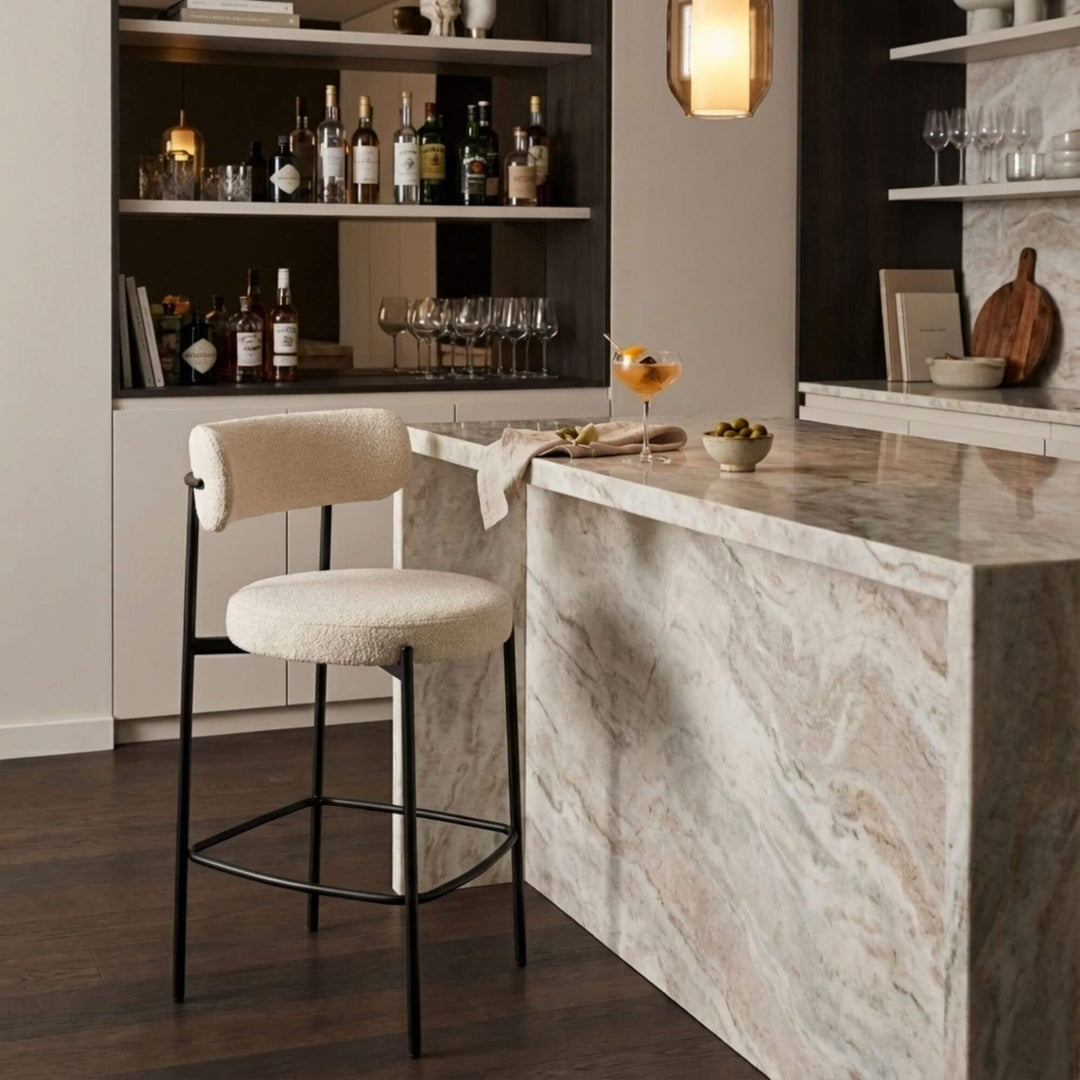 Styled interior view of Gelia Bar Stool placed at a bar counter, highlighting its modern design.