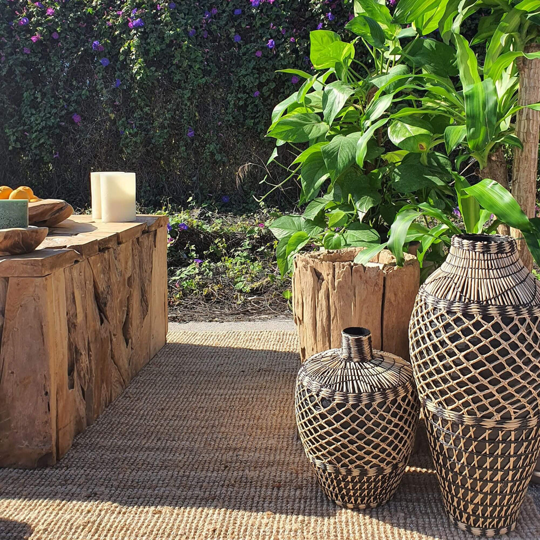 Pair of Ghana baskets styled outdoors beside wooden furniture