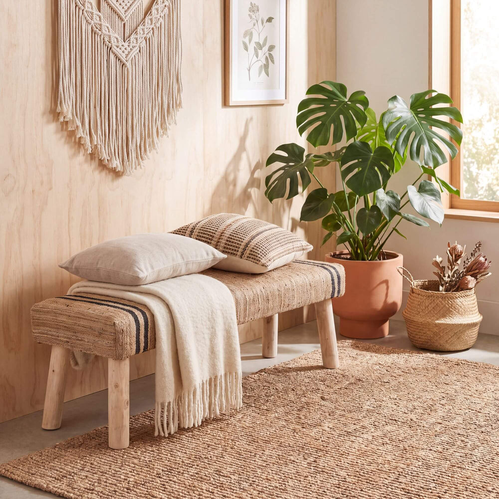Ghana Jute Bench styled with cushions and a throw in a warm natural interior