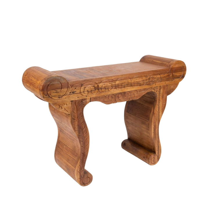 Front view of Gopala carved teak wood console table showcasing its sculptural legs and hand-carved details.