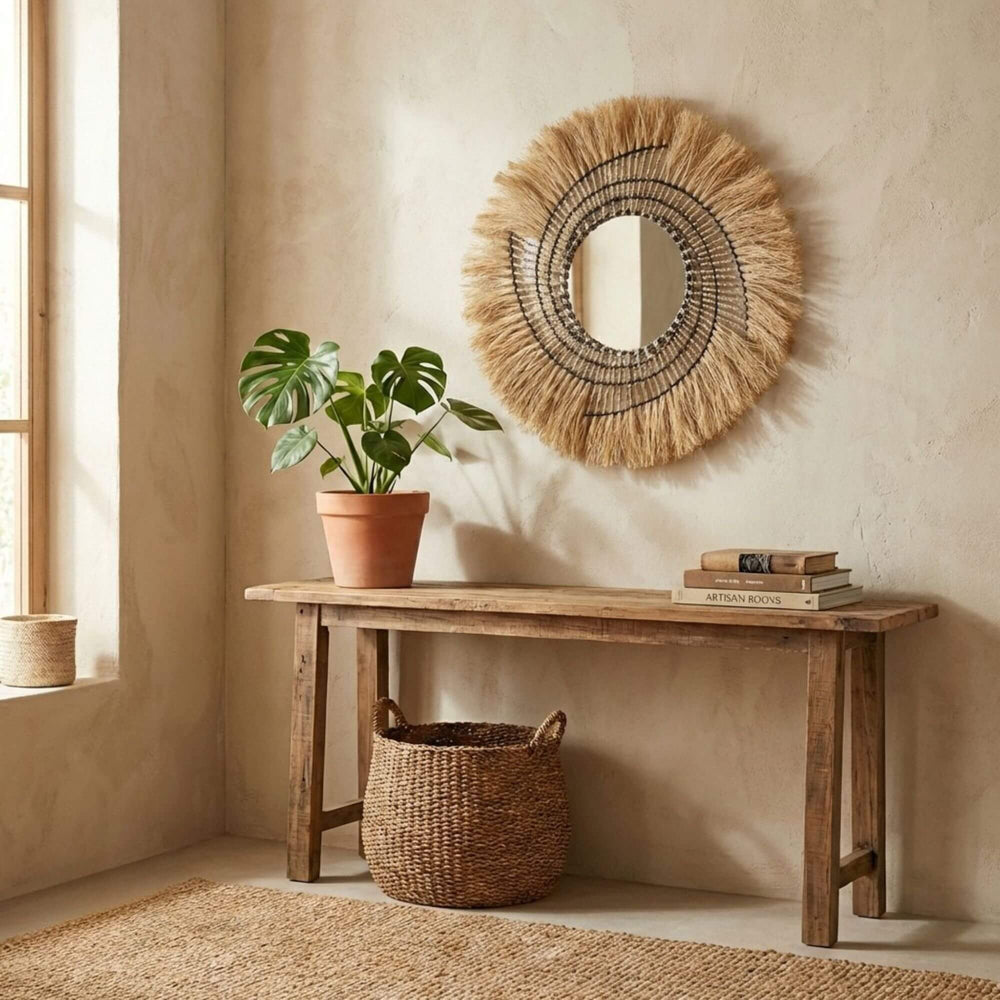 Nest interior design with a wooden console table, plant, and decorative Gora mirror.