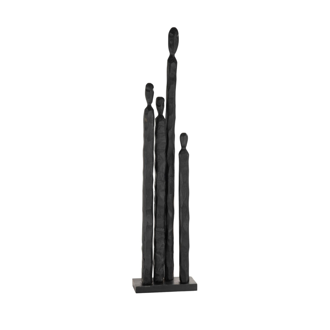 Front view of the Grupi wood figure showing elongated human silhouettes in black.