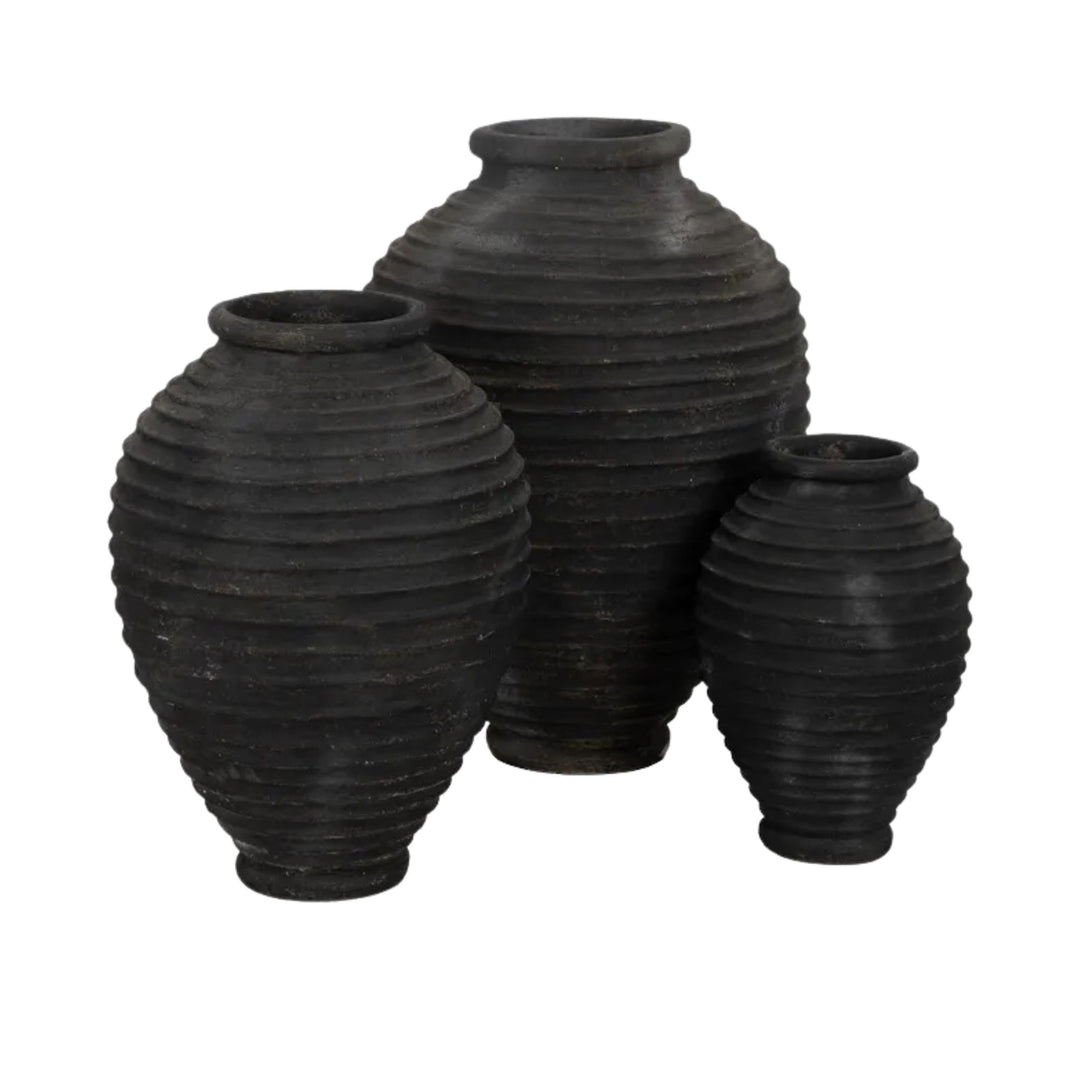 Group of Guarani cement vases showcasing ribbed texture and rounded forms.