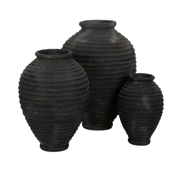 Group of Guarani cement vases showcasing ribbed texture and rounded forms.