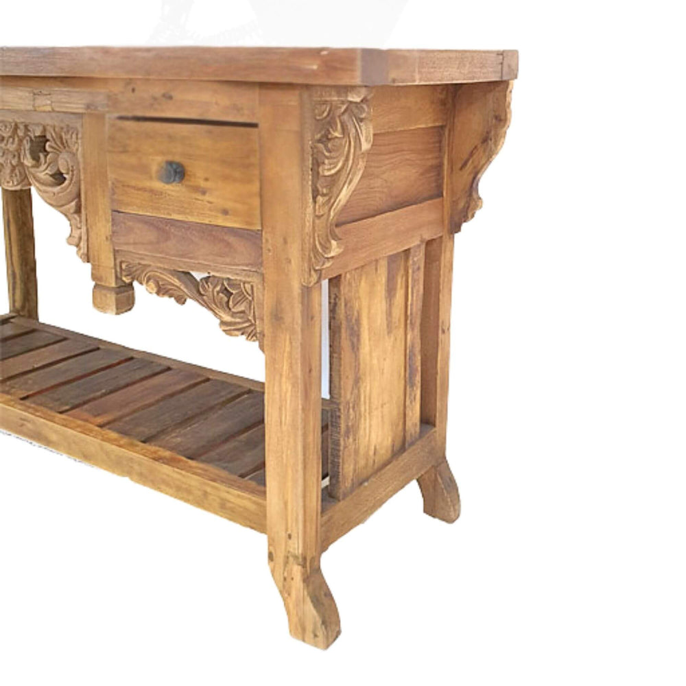 Side angle of Gudrun console table showing carved legs and recycled teak finish.