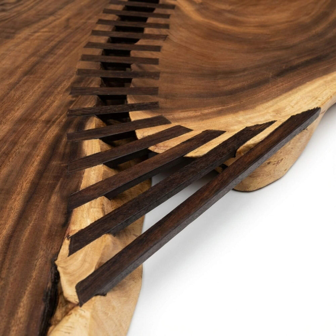 Close-up detail of the handcrafted butterfly joints embedded in the solid wood surface.