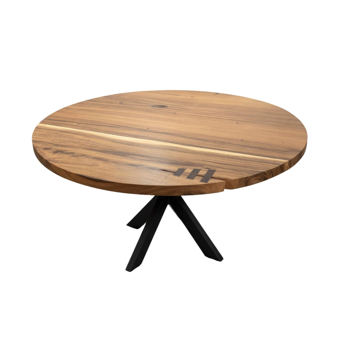 Front view of the Gunung round suar wood dining table with black cross-legs.