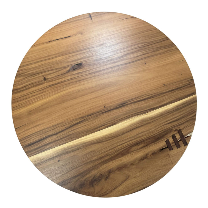 Close-up of the suar wood grain and natural tones on the tabletop.