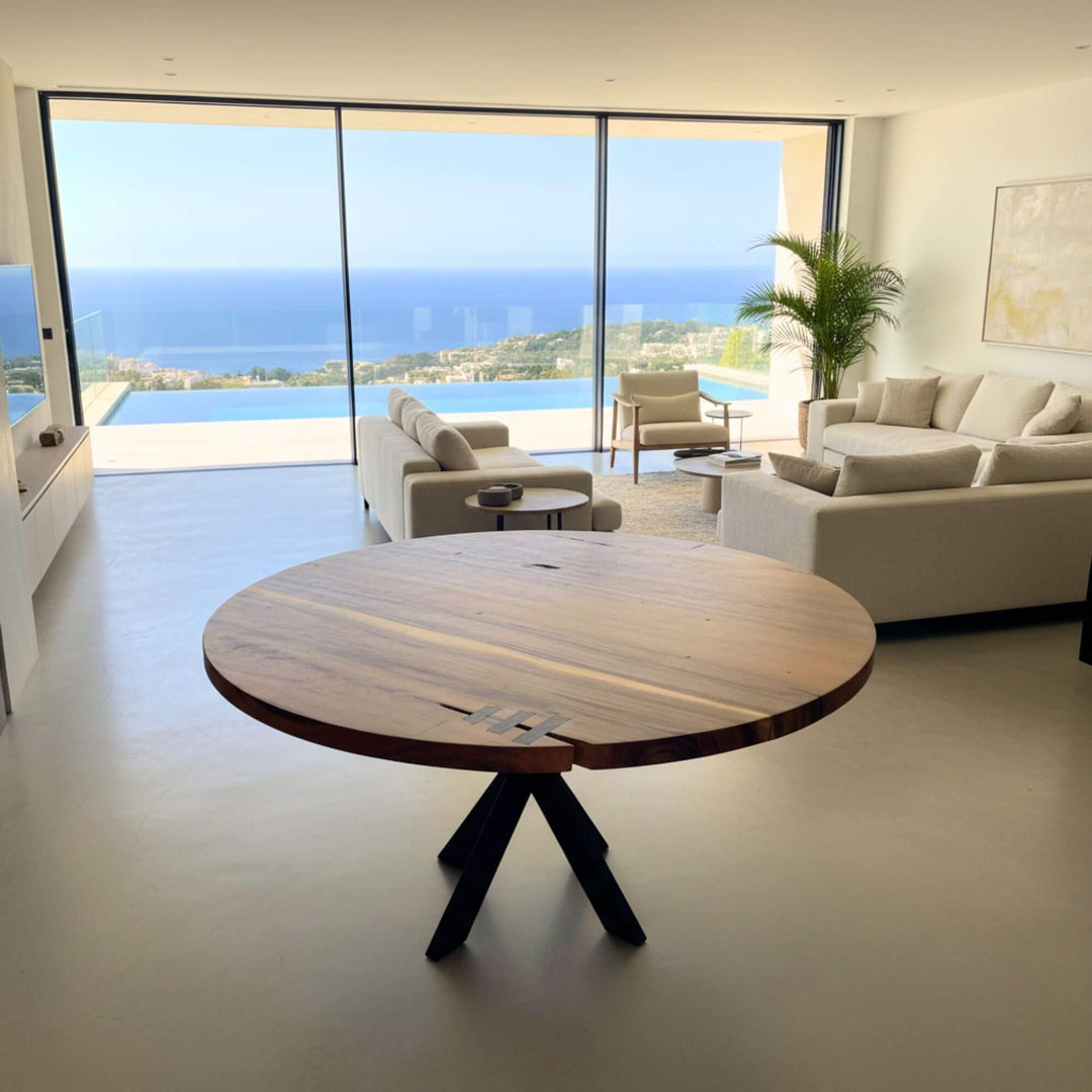 Dining area with the Gunung suar table as the focal point against panoramic windows.