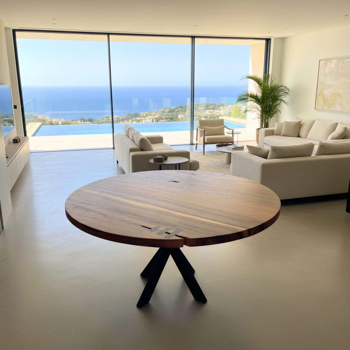 Dining area with the Gunung suar table as the focal point against panoramic windows.