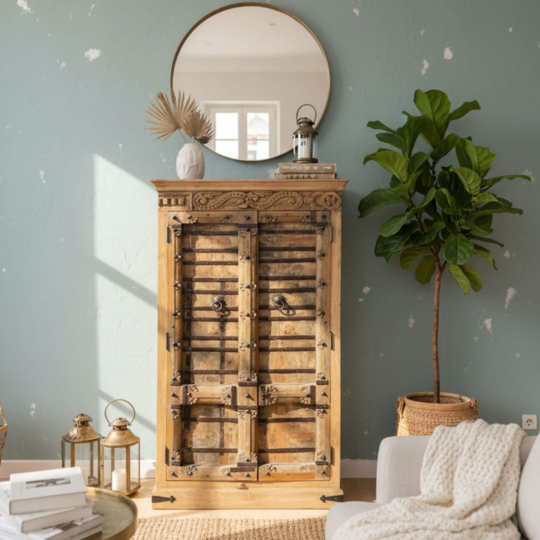 Styled room setting with the Halfor teak wardrobe beside a mirror and soft furnishings.
