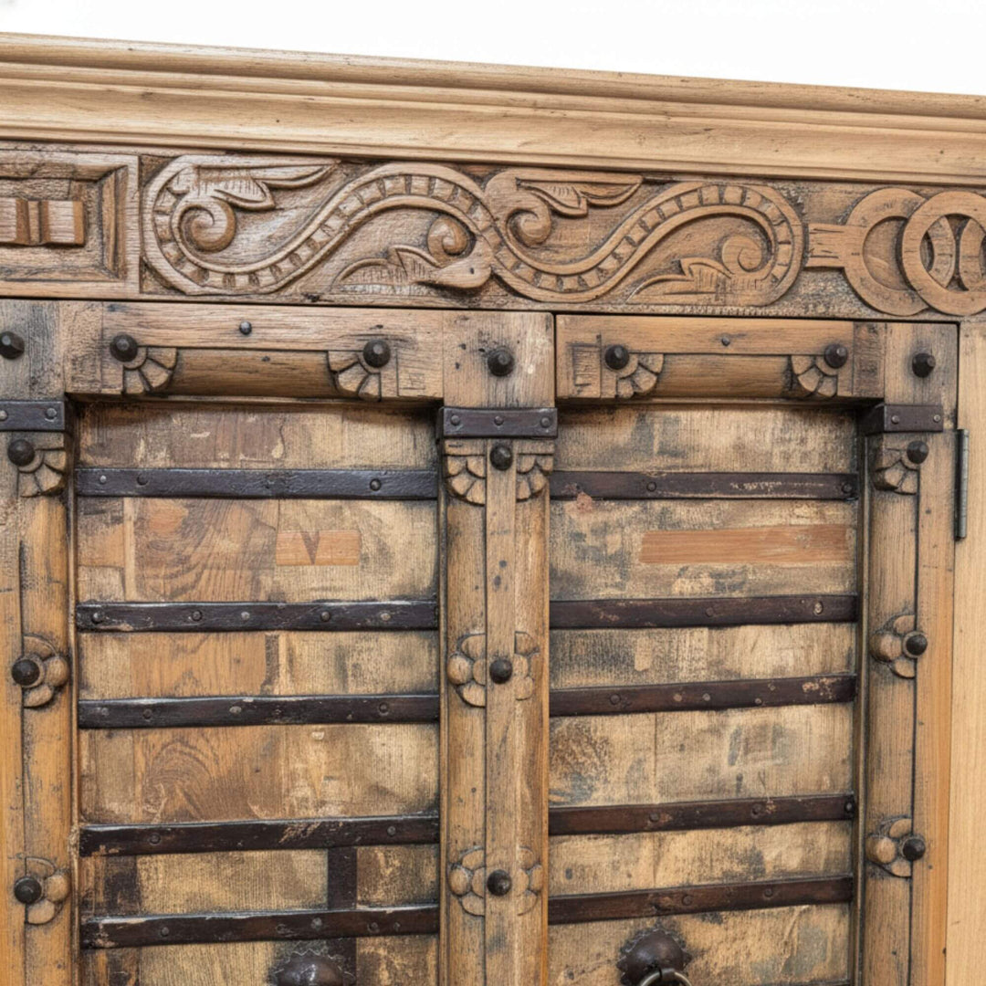 Close-up of the carved teak details on the wardrobe.