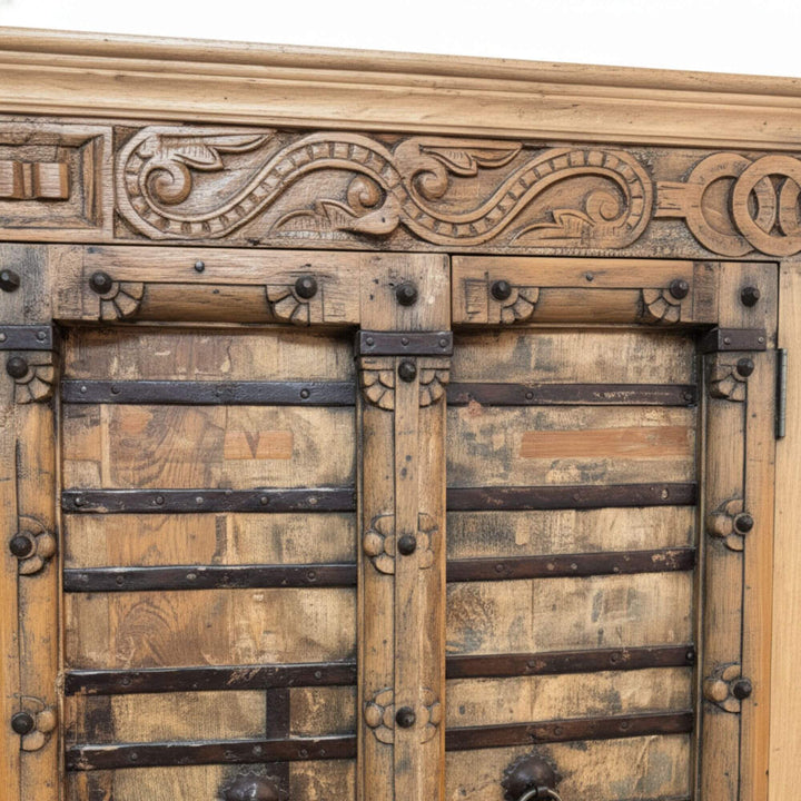 Close-up of the carved teak details on the wardrobe.