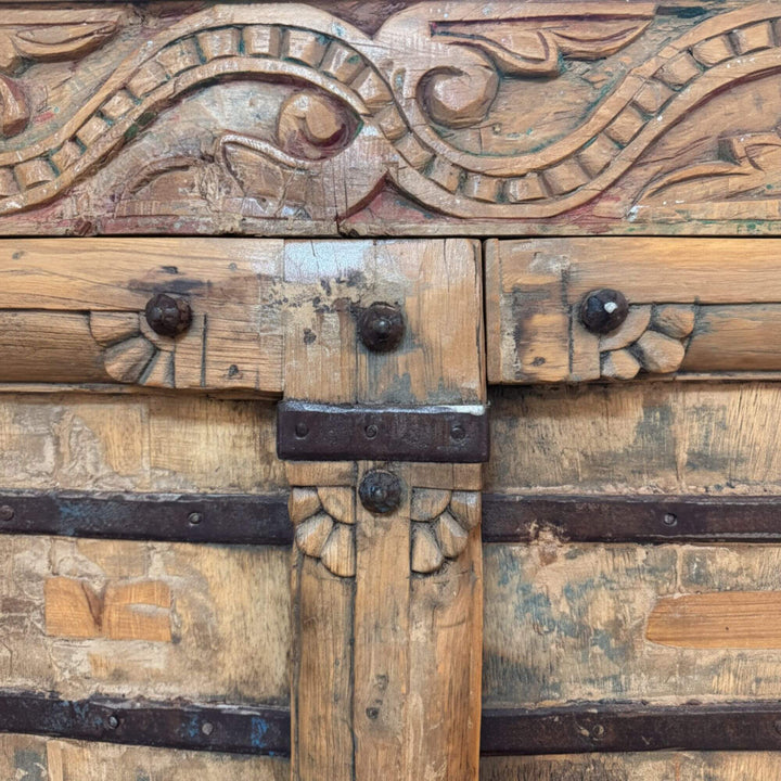 Close-up of the carved teak details on the wardrobe.