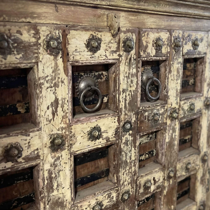 Close-up detail of the aged reclaimed wood doors and metal ring handles.