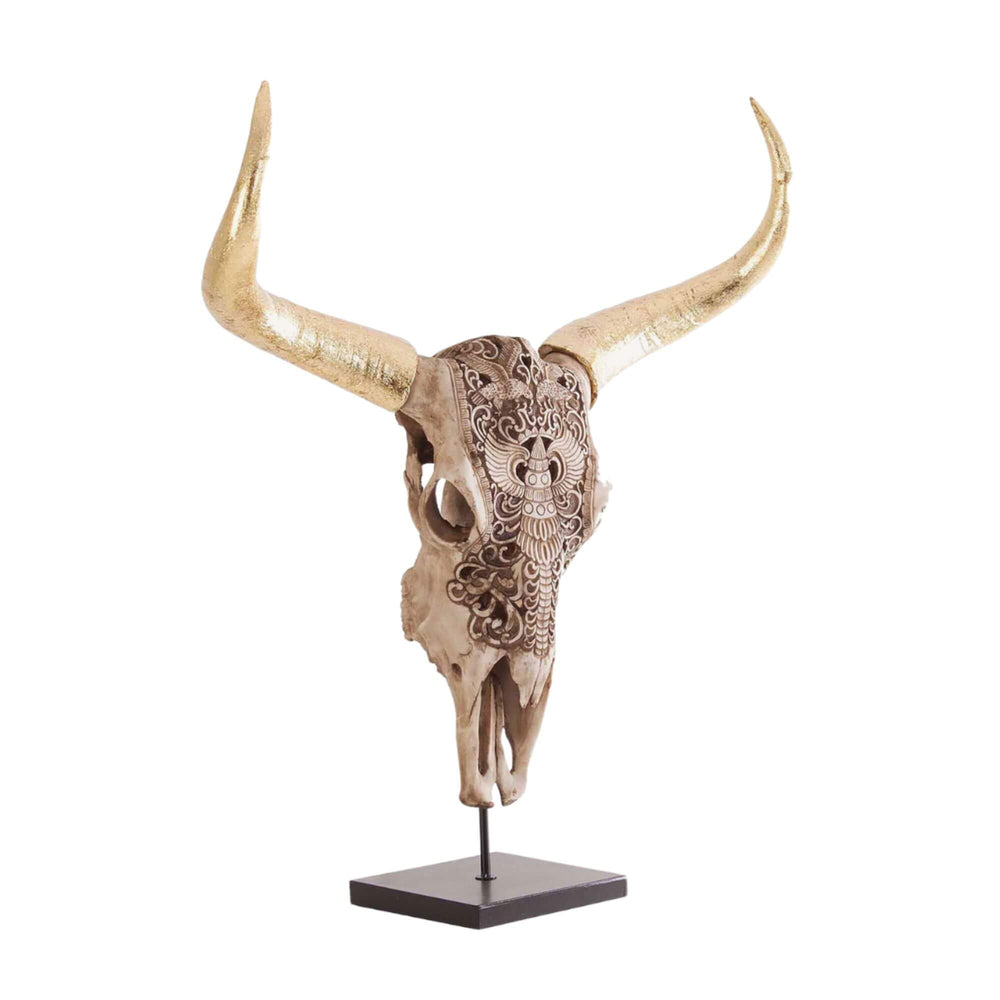 Decorative bull head sculpture on iron base with golden details and engraved motifs.

