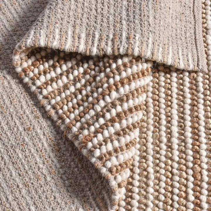Detail view of the rug edge and weave structure showing its handcrafted finish.