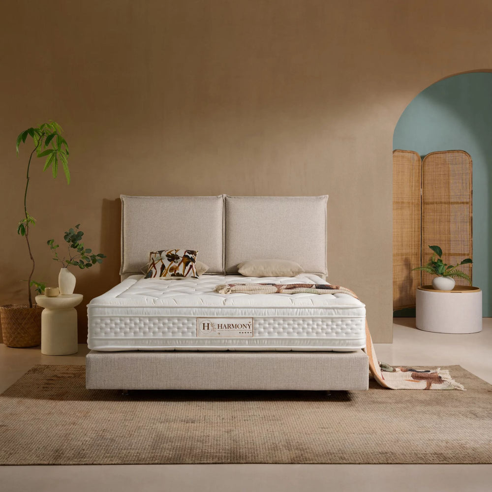 Styled bedroom setting featuring the Harmony Mattress on a modern upholstered base.