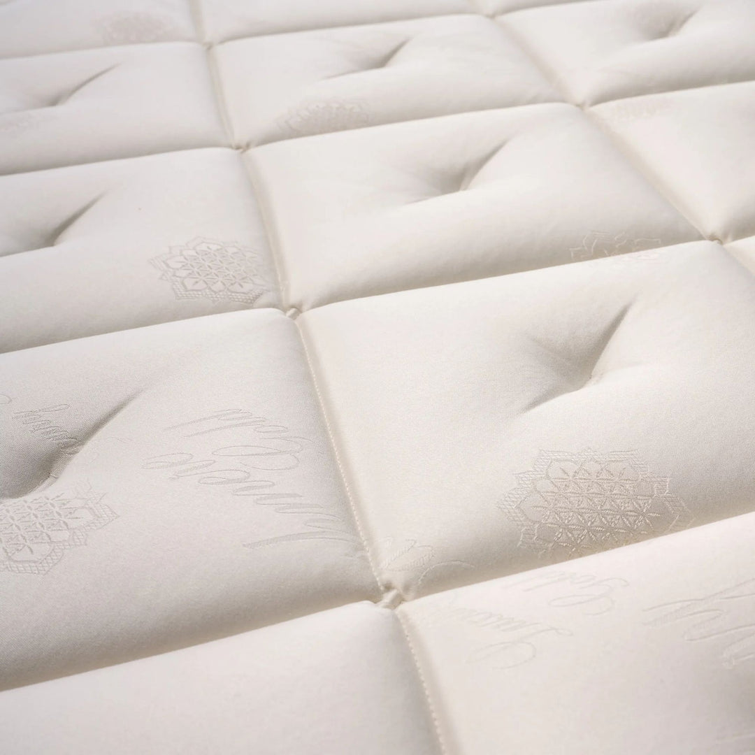 Close-up of the quilted top surface showcasing stitching, texture, and natural fiber detailing.